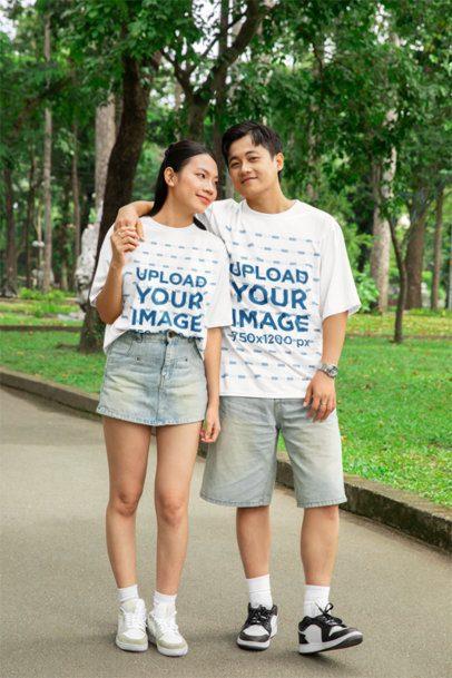 Oversized T-Shirt Mockup Featuring a Happy Man Hugging a Woman in a Park