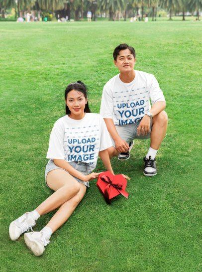 Oversized Tee Mockup of a Man and a Woman Posing in the Park With a Valentine's Day Gift