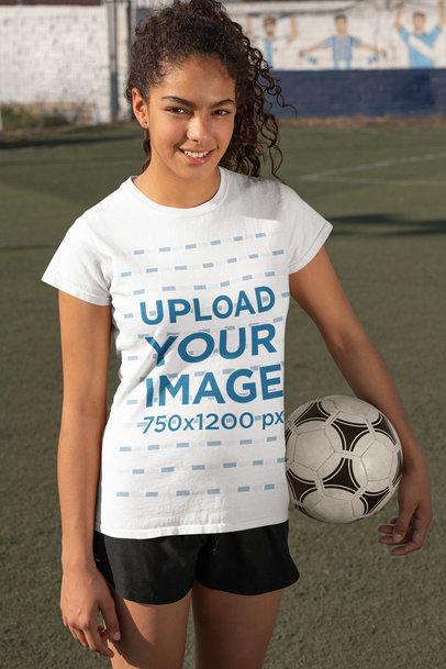 T-Shirt Mockup Featuring a Female Soccer Player Holding a Ball